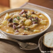 Fresh cabbage stew with potatoes, meat and beans close up